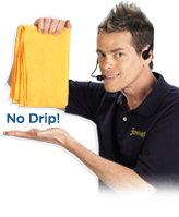 Vince Offer holding up a ShamWow and showing there is no drips after cleaning up a mess